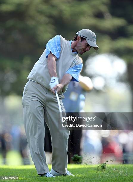 Mike Weir of Canada and the International Team hits his second shot at the 5th hole during the Day Two Fourball Matches in The Presidents Cup at...