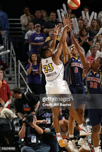 Cappie Pondexter of the Phoenix Mercury shoots against Tammy Sutton-Brown and Ebony Hoffman of the Indiana Fever during Game Five of the WNBA Finals...