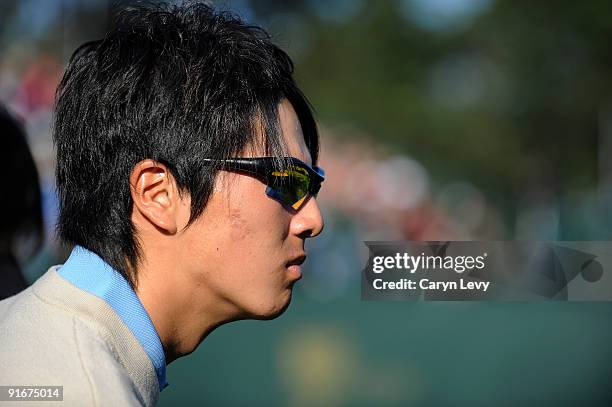 Ryo Ishikawa watches his teammates during the second round four-ball matches for The Presidents Cup at Harding Park Golf Club on October 9, 2009 in...