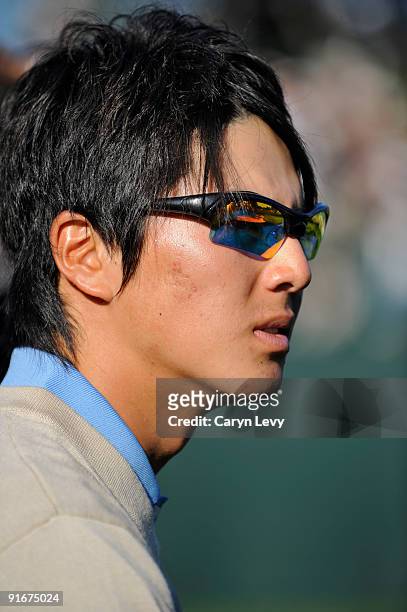 Ryo Ishikawa watches his teammates during the second round four-ball matches for The Presidents Cup at Harding Park Golf Club on October 9, 2009 in...