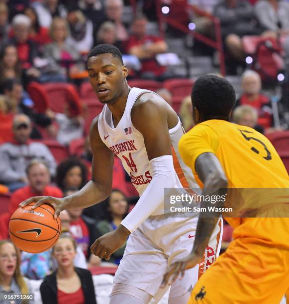 Brandon McCoy of the UNLV Rebels dribbles against Alan Herndon of the Wyoming Cowboys during their game at the Thomas & Mack Center on February 10,...