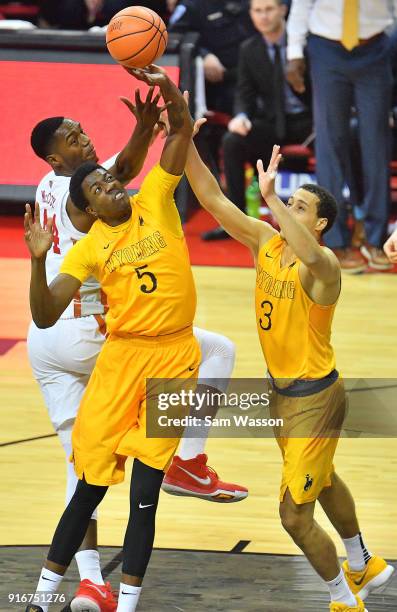 Alan Herndon and Alexander Aka Gorski of the Wyoming Cowboys battle for a rebound against Brandon McCoy of the UNLV Rebels during their game at the...