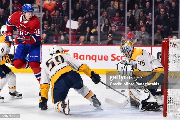 Nikita Scherbak of the Montreal Canadiens jumps as he gets a shot on goaltender Pekka Rinne of the Nashville Predators during the NHL game at the...