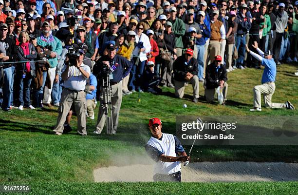 Tiger Woods chips out of the bunker onto the 14th green the during the second round four-ball matches for The Presidents Cup at Harding Park Golf...