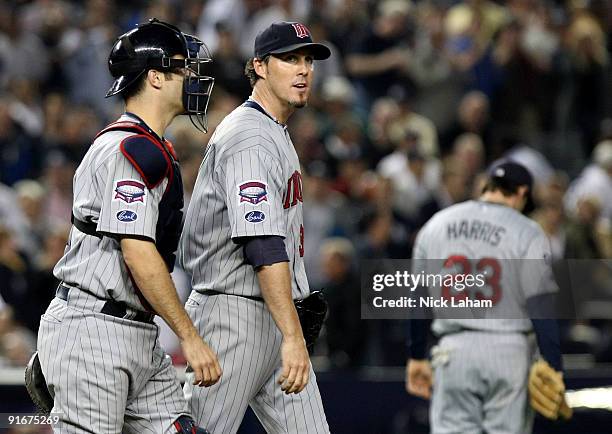 Joe Mauer talks with Joe Nathan of the Minnesota Twins after an erron in the tenth inning against the New York Yankees in Game Two of the ALDS during...