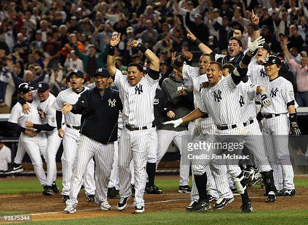 Melky Cabrera, Alex Rodriguez and the New York Yankees celebrate the walk off home run in the eleventh inning against the Minnesota Twins in Game Two...