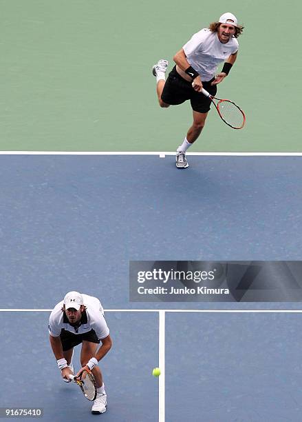 Christopher Kas of Germany and Jaroslav Levinsky of the Czech Republic serve in their doubles match against Ross Hutchins of Great Britain and Jordan...