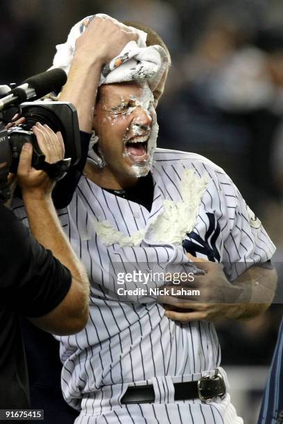 Mark Teixeira of the New York Yankees gets a pie in the face by teammate A.J. Burnett after hitting a walk off home run in the eleventh inning...