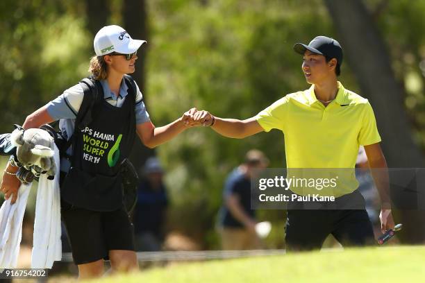 Min Woo Lee of Australia fist bumps his caddie while walking to the 6th green in the round 2 match agaiunst Prom Meesawat of Thailand during day four...