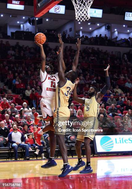 Western Kentucky Hilltoppers guard Taveion Hollingsworth shoots over the arms of Florida International Golden Panthers forward Osasumwen Osaghae...