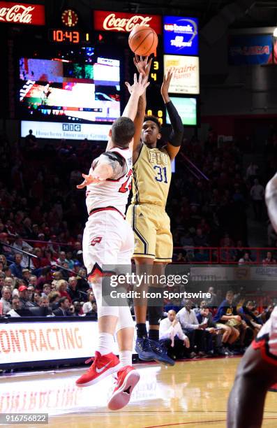 Florida International Golden Panthers forward Michael Douglas shoots over the arms of Western Kentucky Hilltoppers forward Justin Johnson during the...