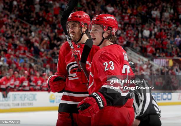 Brock McGinn of the Carolina Hurricanes celebrates with teammate Trevor van Riemsdyk after scoring a goal during an NHL game against the Colorado...