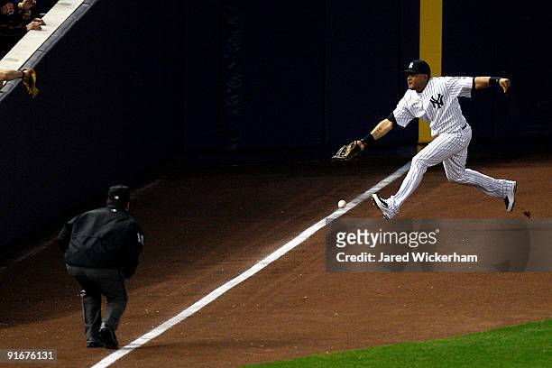 Melky Cabrera of the New York Yankees fails to make a play on a ball that lands fair but is called foul by umpire Phil Cuzzi in the eleventh inning...