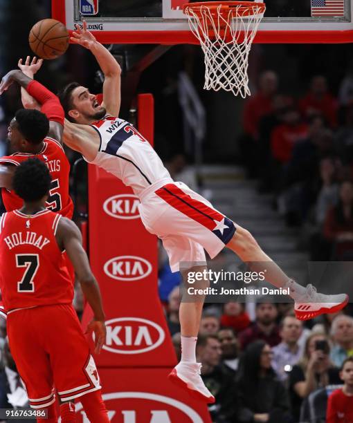 Tomas Satoransky of the Washington Wizards suffers a flagrant foul by Bobby Portis of the Chicago Bulls late in the game at the United Center on...