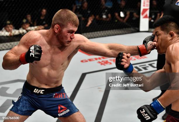 Jake Matthews of Australia punches Li Jingliang of China in their welterweight bout during the UFC 221 event at Perth Arena on February 11, 2018 in...
