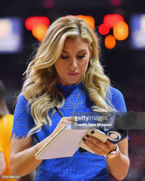 Sideline reporter Melanie Collins takes notes during a timeout of a game between the UNLV Rebels and the Wyoming Cowboys at the Thomas & Mack Center...