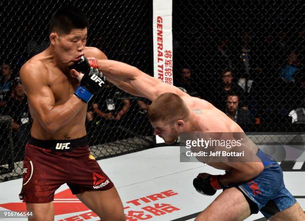 Jake Matthews of Australia punches Li Jingliang of China in their welterweight bout during the UFC 221 event at Perth Arena on February 11, 2018 in...