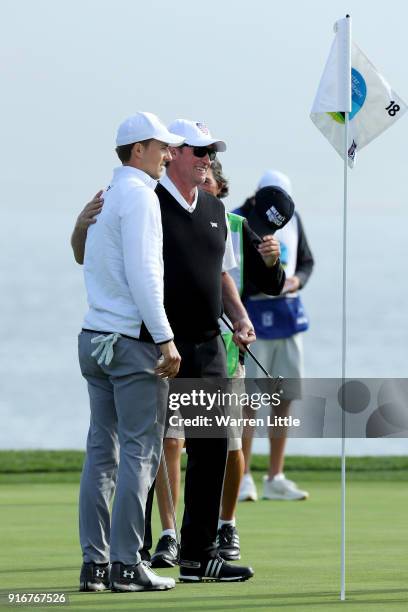 Jordan Spieth and Wayne Gretzky meet after finishing their round on the 18th green during Round Three of the AT&T Pebble Beach Pro-Am at Pebble Beach...
