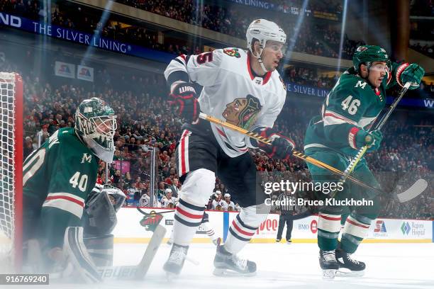 Devan Dubnyk and Jared Spurgeon of the Minnesota Wild defend against Artem Anisimov of the Chicago Blackhawks during the game at the Xcel Energy...