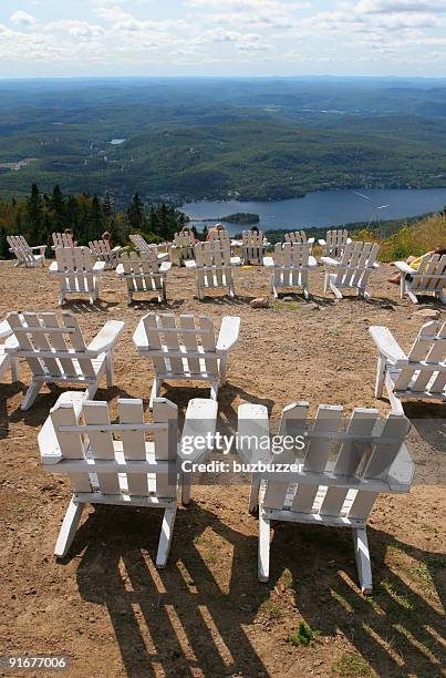 multiple white chairs on top of mount tremblant - buzbuzzer stock pictures, royalty-free photos & images