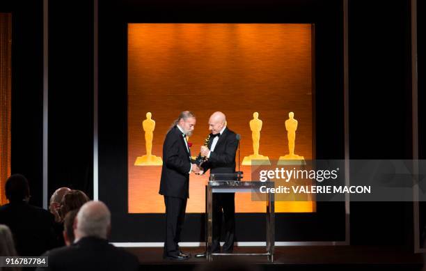 Actor Sir Patrick Stewart gives the Oscar to Visual effects technologist Jonathan Erland, recipient of the Gordon E. Sawyer Award during the Academy...