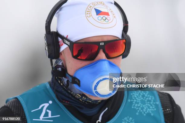 Czech Republic's Petr Knop, wearing a breathing mask, arrives to take the start of the men's 15km + 15km cross-country skiathlon at the Alpensia...