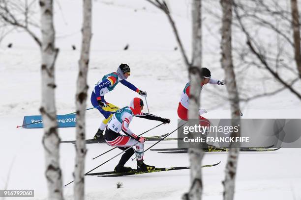 Athletes Austria's Max Hauke , Japan's Keishin Yoshida and Andorra's Irineu Esteve Altimiras compete in the men's 15km + 15km cross-country skiathlon...