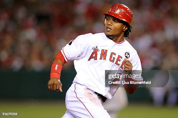 Erick Aybar of the Los Angeles Angels of Anaheim runs safely to third base against the Boston Red Sox in Game Two of the ALDS during the 2009 MLB...