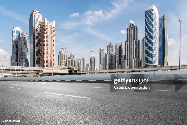 traffic on street - dubai skyline daytime stock pictures, royalty-free photos & images