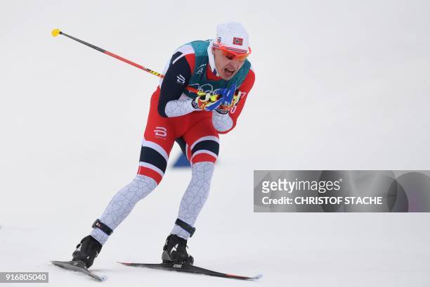 Norway's Simen Hegstad Krueger sprints to win the men's 15km + 15km cross-country skiathlon at the Alpensia cross country ski centre during the...
