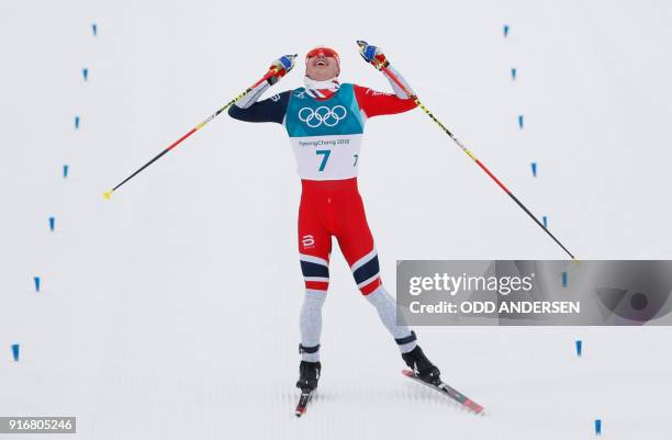 Norway's Simen Hegstad Krueger celebrates winning gold at the end of the men's 15km + 15km cross-country skiathlon at the Alpensia cross country ski...