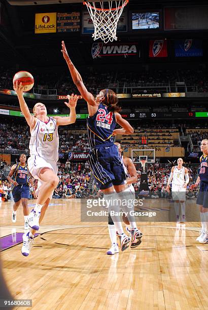 Penny Taylor of the Phoenix Mercury drives for a shot against Tamika Catchings of the Indiana Fever in Game five of the WNBA Finals played on October...