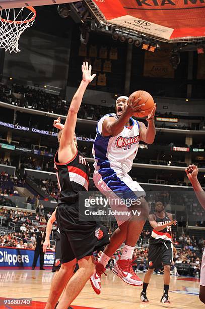 Craig Smith of the Los Angeles Clippers puts up a shot against Joel Przybilla of the Portland Trail Blazers at Staples Center on October 9, 2009 in...