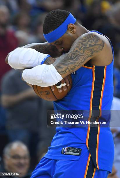 Carmelo Anthony of the Oklahoma City Thunder cradles the ball prior to the start of an NBA basketball game against the Golden State Warriors at...