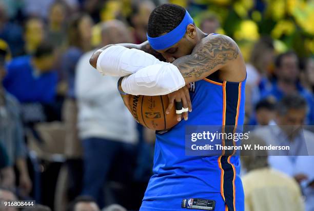 Carmelo Anthony of the Oklahoma City Thunder cradles the ball prior to the start of an NBA basketball game against the Golden State Warriors at...