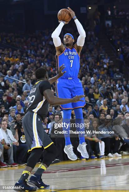 Carmelo Anthony of the Oklahoma City Thunder shoots over Draymond Green of the Golden State Warriors during the first half of their NBA basketball...