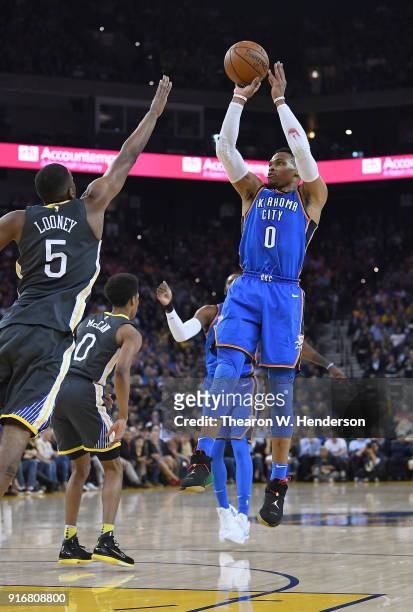Russell Westbrook of the Oklahoma City Thunder shoots over Kevon Looney of the Golden State Warriors during the first half of their NBA basketball...