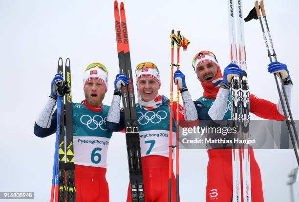 Simen Hegstad Krueger of Norway celebrates winning the gold medal with silver medallist Martin Johnsrud Sundby of Norway and bronze medallist Hans...