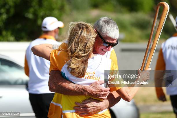 400m Hurdles Olympic Gold Medallist Debbie Flintoff-King is hugged by Paul Olsson carries the Queens Baton during the Queens Baton Commonwealth Games...