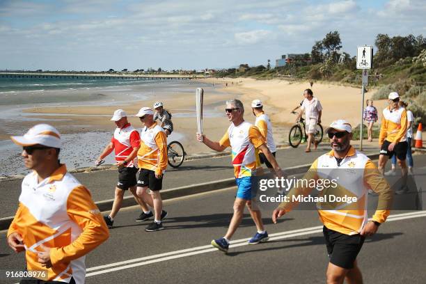 Paul Olsson carries the Queens Baton during the Queens Baton Commonwealth Games relay in Frankston on February 11, 2018 in Melbourne, Australia.