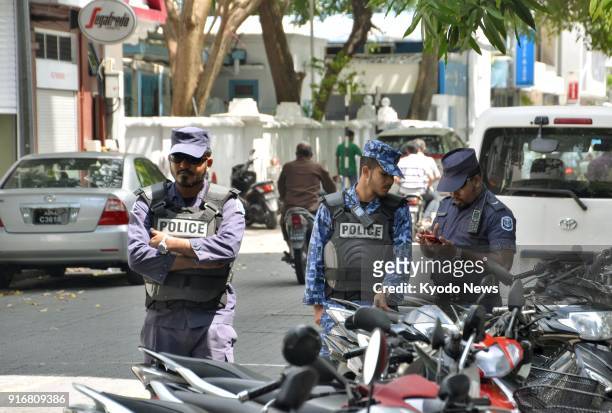 Maldives police officers stand guard on a street in the capital Male on Feb. 9 after President Abdulla Yameen of the Indian Ocean islands country...