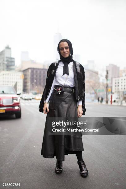 Mademoiselle Meme is seen on the street attending R13 during New York Fashion Week wearing a black sweater with leather skirt on February 10, 2018 in...