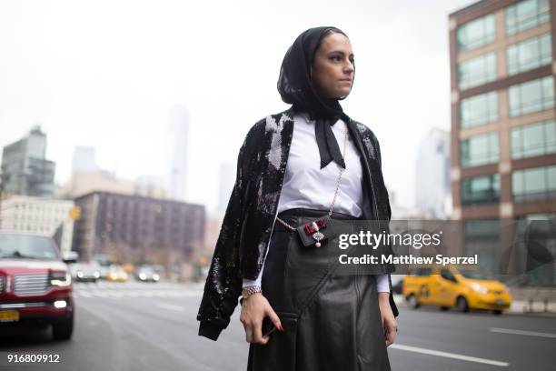 Mademoiselle Meme is seen on the street attending R13 during New York Fashion Week wearing a black sweater with leather skirt on February 10, 2018 in...