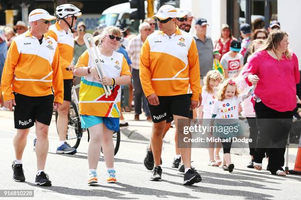 Lisa McLeish, who was told at the age of 4 she would never walk again due to illness, carries the Queens Baton during the Queens Baton Commonwealth...