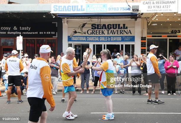 Lisa McLeish, who was told at the age of 4 she would never walk again due to illness, receives the Queens Baton from Trevor Vincent during the Queens...