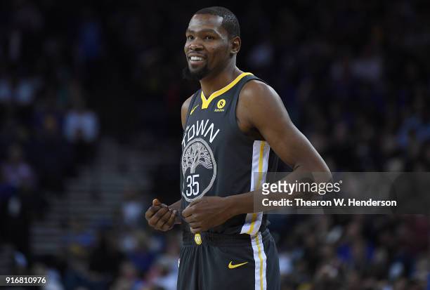 Kevin Durant of the Golden State Warriors looks on smiling against the Oklahoma City Thunder during their NBA basketball game at ORACLE Arena on...