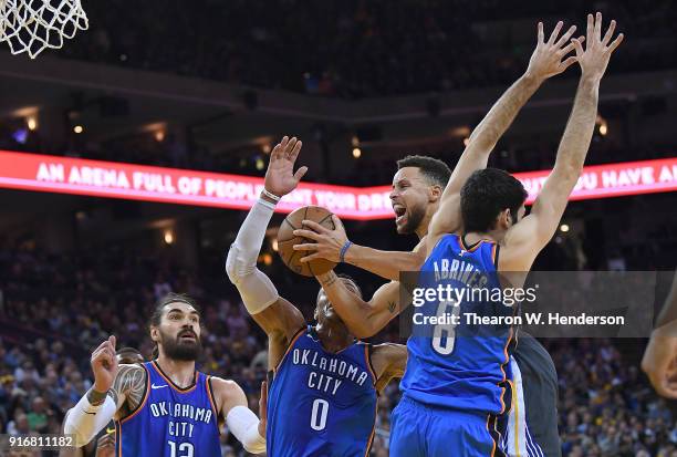 Stephen Curry of the Golden State Warriors goes in for a layup and gets fouled by Alex Abrines of the Oklahoma City Thunder during the second half of...