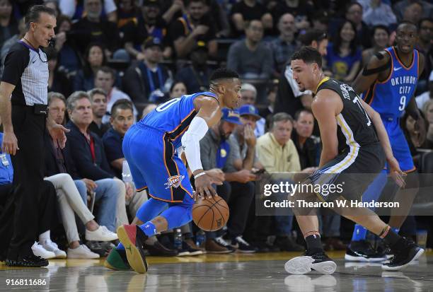 Russell Westbrook of the Oklahoma City Thunder dribbles the ball while guarded by Klay Thompson of the Golden State Warriors during the second half...