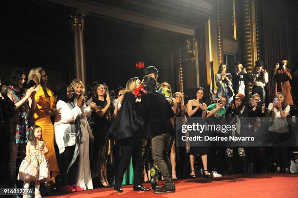 Designer Christian Siriano gets flowers and a hug on the runway for the Christian Siriano fashion show during New York Fashion Week at the Grand...