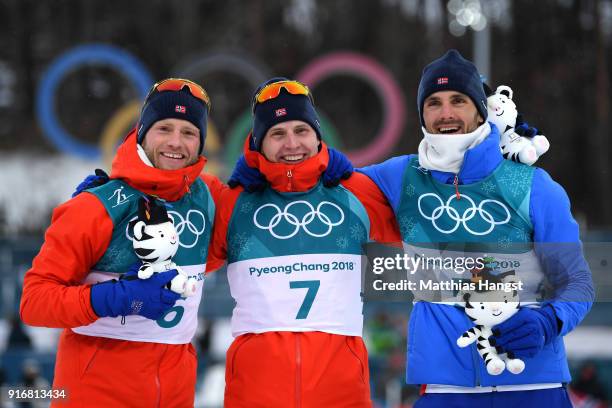 Simen Hegstad Krueger of Norway celebrates winning the gold medal with silver medallist Martin Johnsrud Sundby of Norway and bronze medallist Hans...